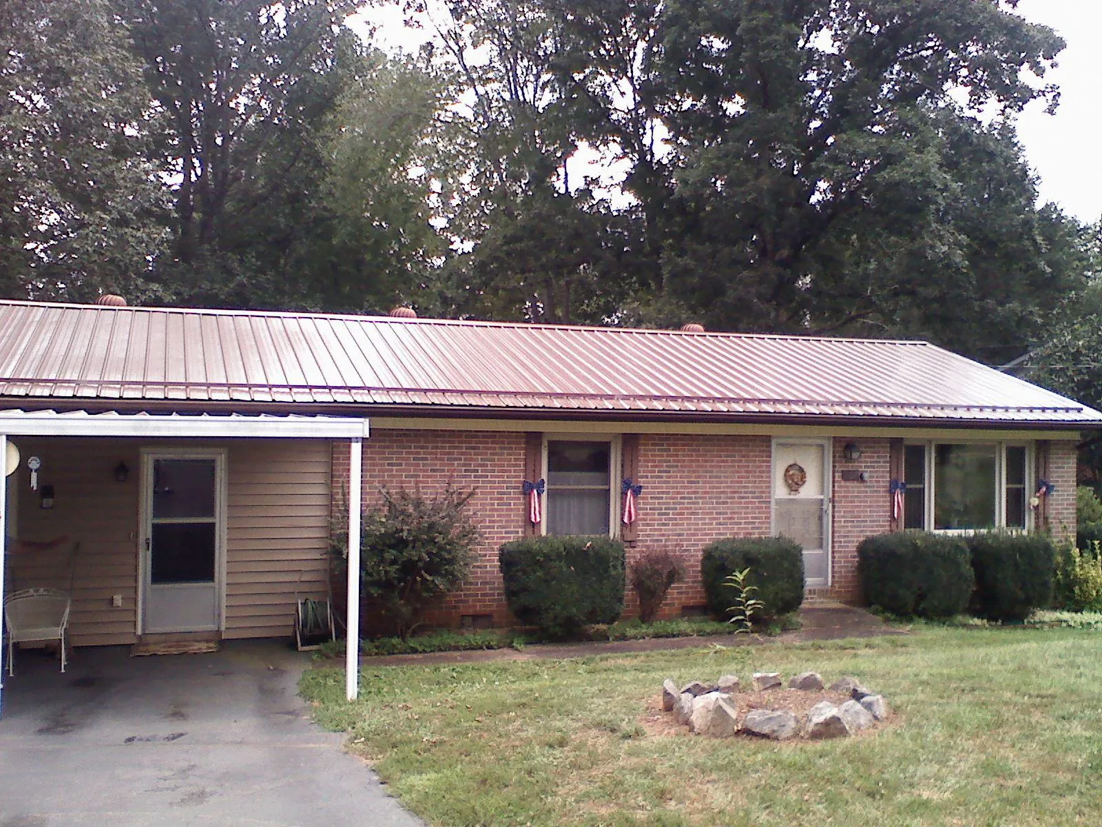 Bronze metal roof and carport on a brick ranch home — Roof Repair work by our crew in Garards Fort